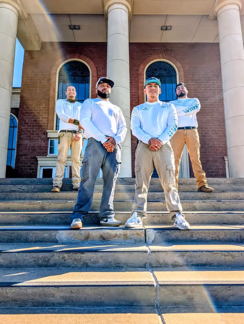 Diamond State Plumbing crew standing on steps of brick building