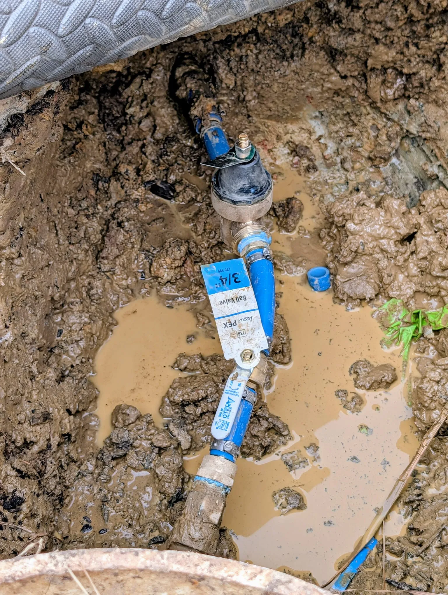 Plumber repairing a leaking pipe in a west Little Rock home