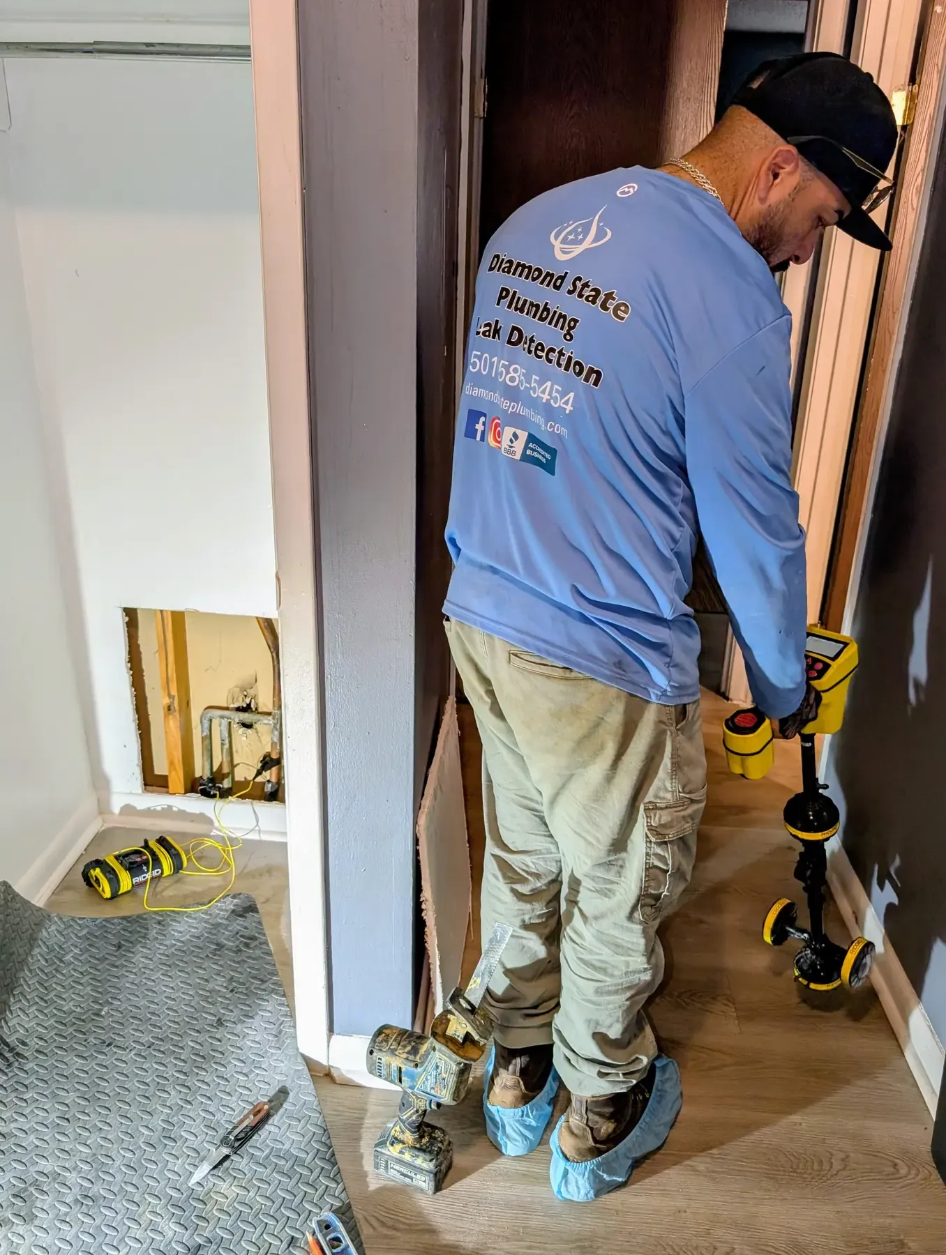 Diamond State Plumbing technician locating water pipes with electronic detection equipment