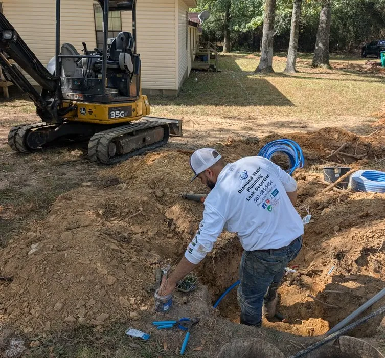 Excavated trench with old and new water service lines