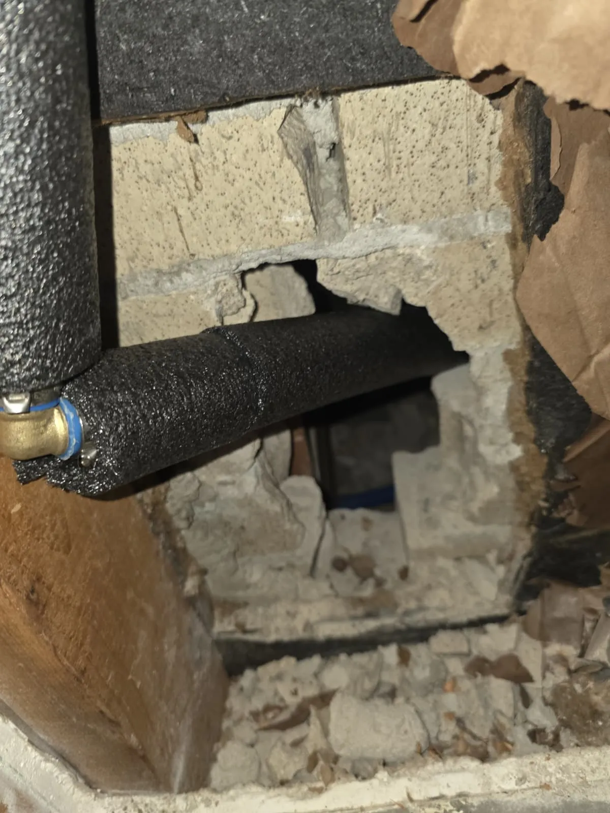 Foam-insulated water line routed through a block foundation to protect against freezing