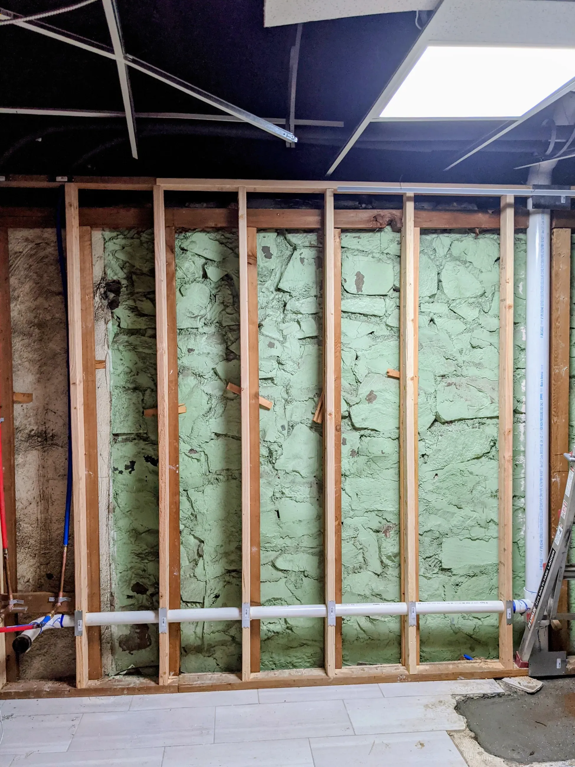 Open wall framing showing where plumbing runs during a renovation