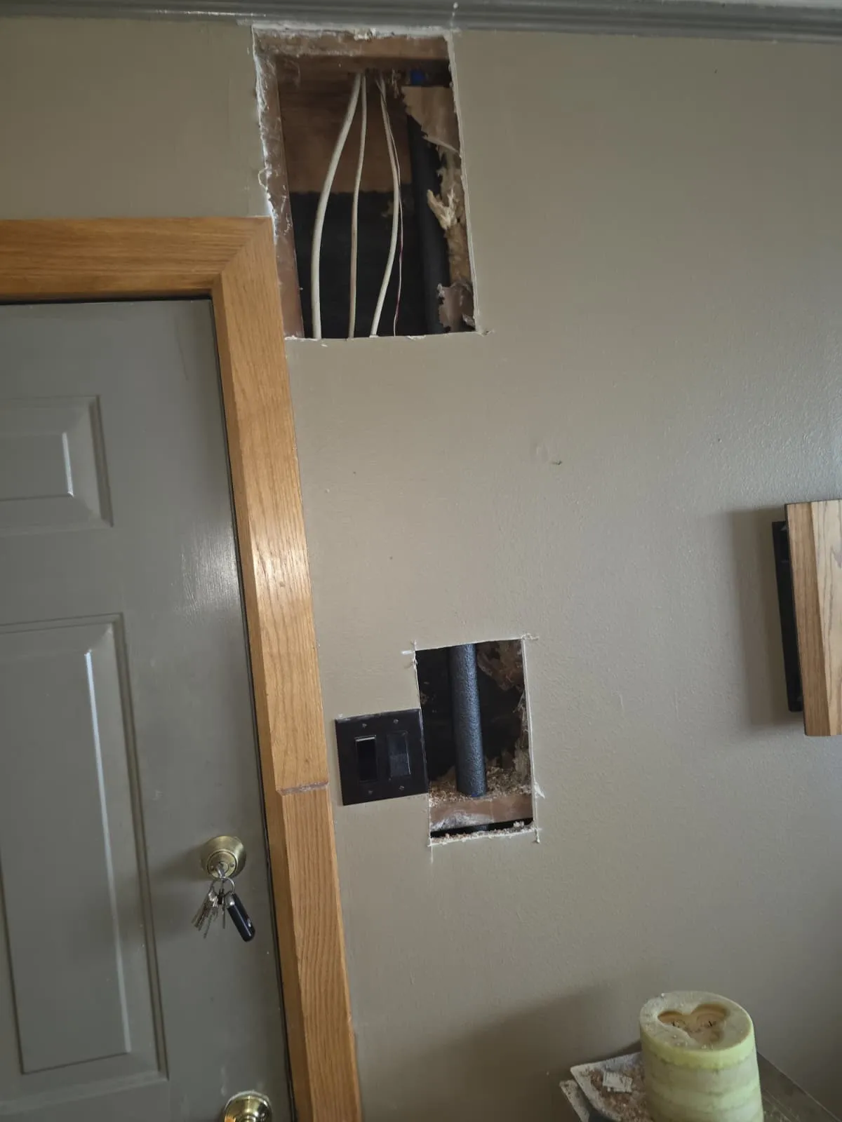 Drywall access openings showing new water lines during a whole-house repipe