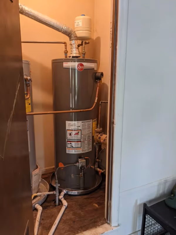Tank water heater installed in a utility closet