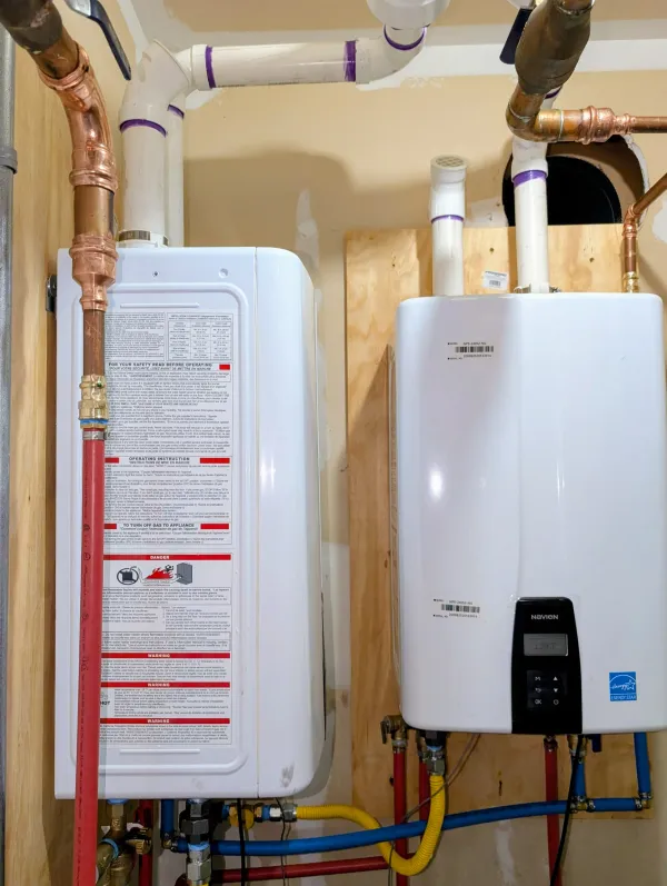 Two Navien tankless water heaters installed on a wall
