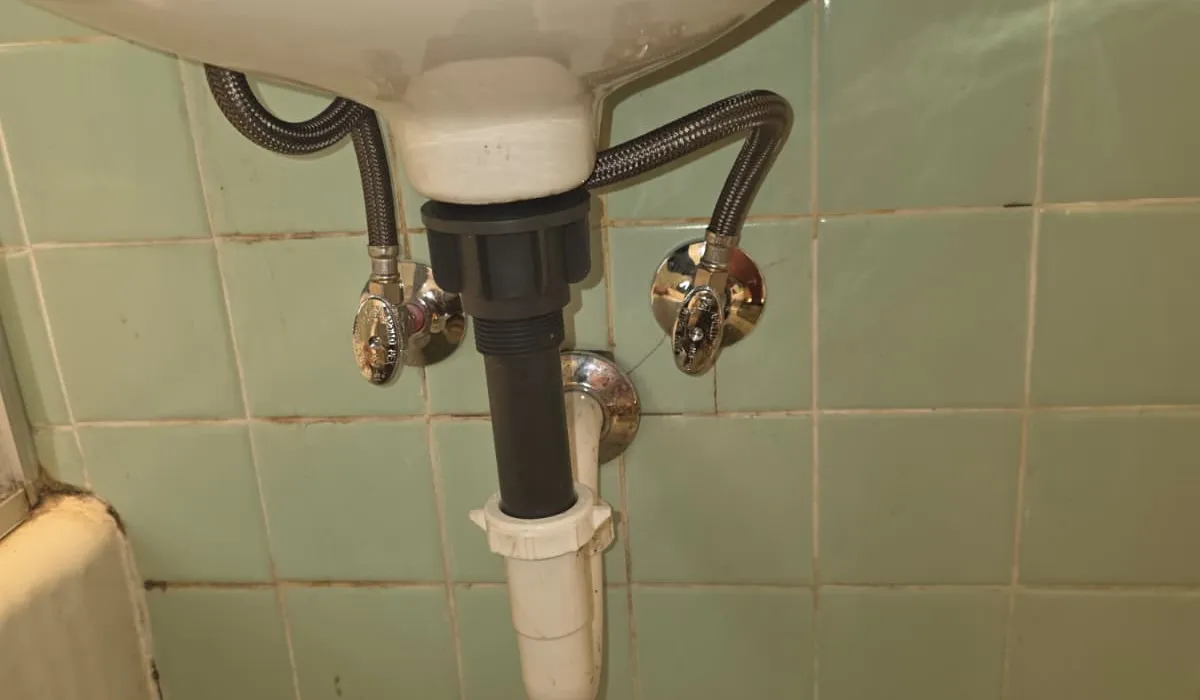 New supply lines, shut-off valves, and P-trap under a bathroom sink