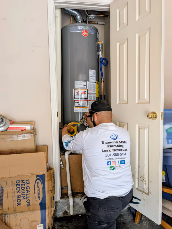 Diamond State Plumbing technician installing a Rheem water heater