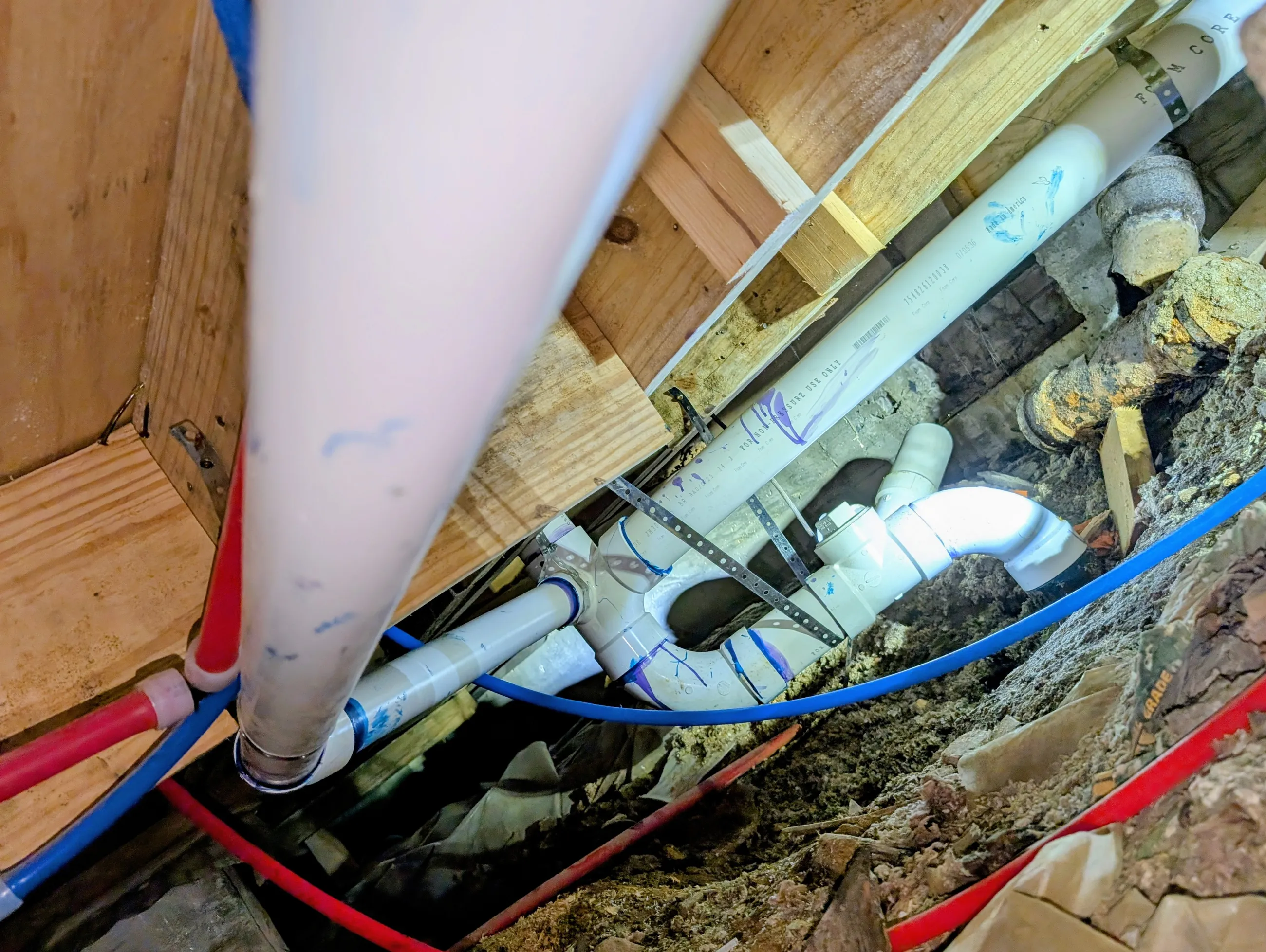 Residential plumbing installation showing drain and water supply pipes